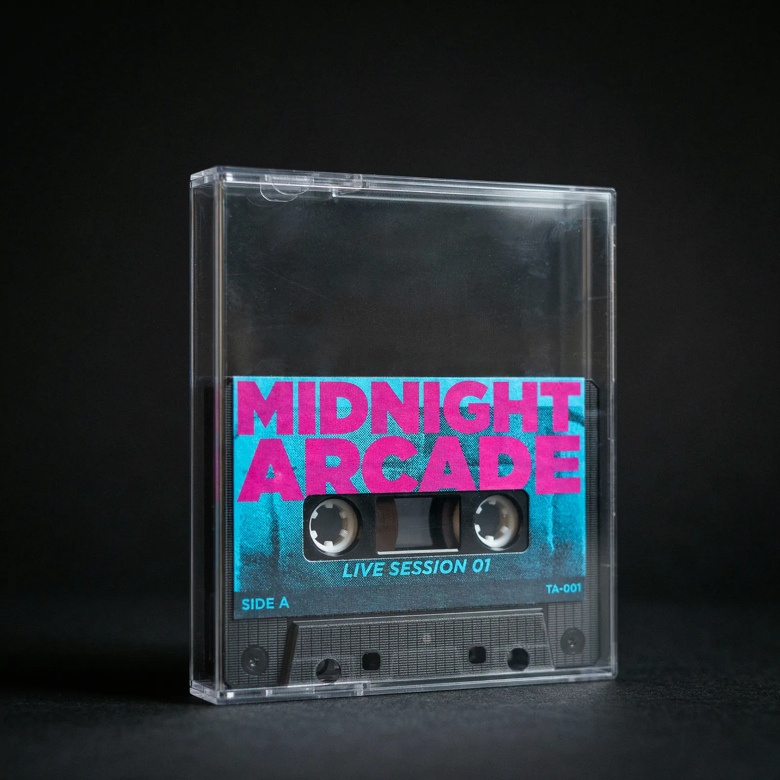 Ideogram v4 Quality product photo of a cassette tape labeled MIDNIGHT ARCADE LIVE SESSION 01